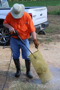 Regional Extension Agent, Rudy Yates, uses a pressure washer to pod blast in Lowndes County.